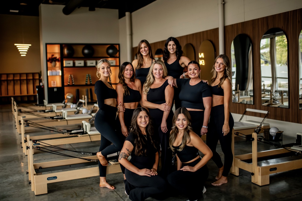 PureForm clients posed together among the Reformers in the Sioux City studio